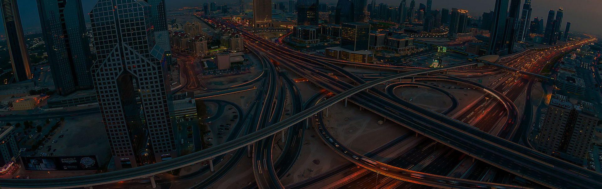 A woman looks at the Dubai skyline from the balcony of a waterfront apartment